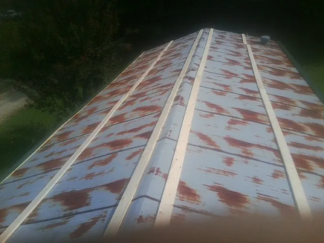 Rusted metal roof panels with new wood purlins before replacement — Storm Damage Roof Repair in Port Matilda by Roofing Brothers
